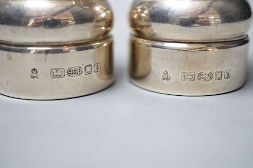A modern pair of silver mounted salt and pepper mills, 10.4cm.